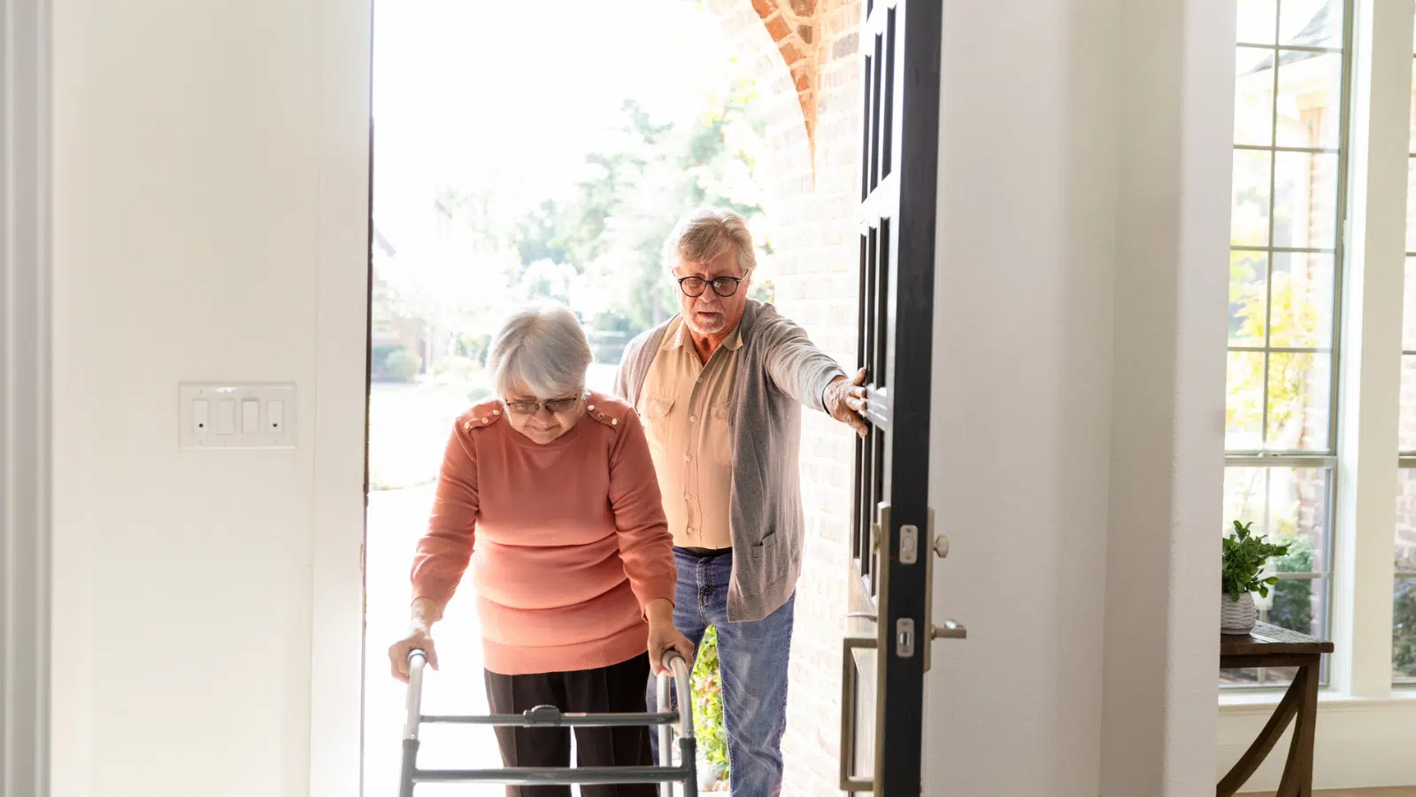 Home Safety Tips for Older Adults Feature Image: Older Couple Entering Home, Assistance and Support