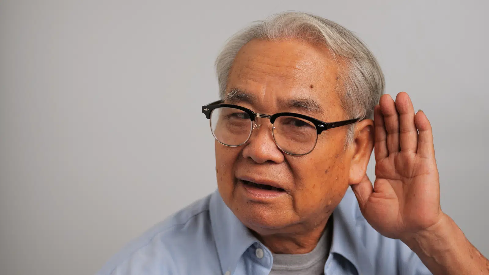 The 5 Main Causes of Vision and Hearing Loss in Older Adults Feature Image: Asian old man couldn't hear the cause of his deafness